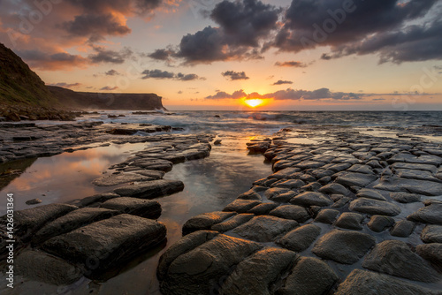 Sunrise sunlight across tessellated rocks Garie Beach photo