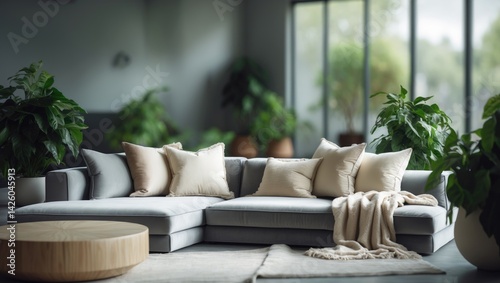 Blurred background of a stylish living room with a light grey sectional sofa, cozy cushions, and throws, exuding warmth and comfort.
