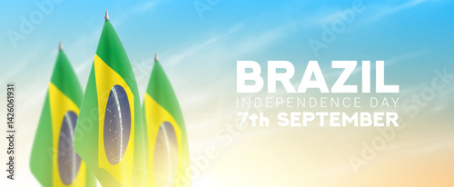 Happy Independence Day of Brazil. Brazilian flags isolated on cloudy sky at sunrise. Realistic flags for decoration Brazilian Independence Day. Vector illustration. Day of Brazil on 7th of September.