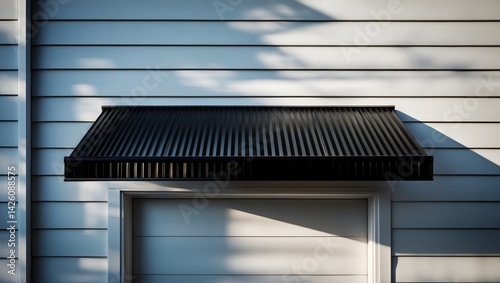Obraz na płótnie Black metal awning with shadowed door on building exterior w salonie