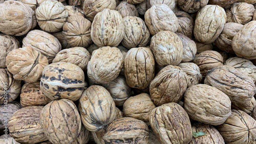 Close-up of stacked walnuts symbolizing autumn harvest and healthy eating, perfect for Thanksgiving and nutrition-themed projects Close-up of stacked walnuts symbolizing autumn harvest and healthy eating, perfect for Thanksgiving and nutrition-themed projects