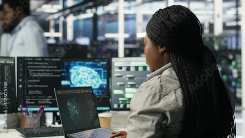 Data center admin uses AI technology on laptop for machine learning workloads. Server hub worker using artificial intelligence on notebook to perform demanding computing tasks, camera B