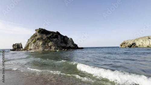 Serene beach scene with blue sky, clouds and rocks in the sea, Sile, Turkey. Black Sea view