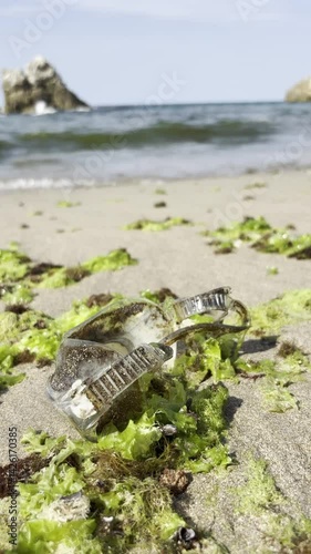 Waste plastic diving goggles that will be brought to the beach by waves. Plastic pollution and environmental problem concept. Recycle reduce and reuse