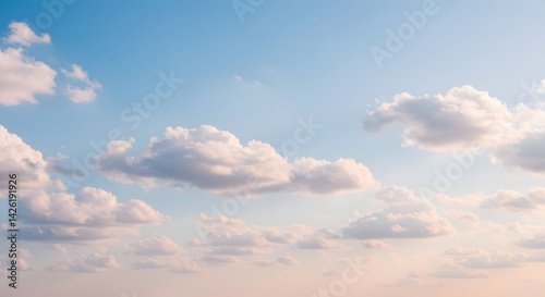 Clouds Drifting in Blue Sky at Sunset with Warm Sunlight