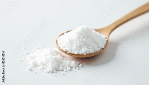 Spoonful of white sugar against white backdrop, white sugar, sparkling