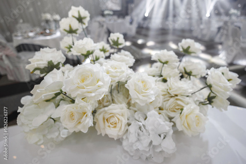 Close-up of the decor of white flowers at the wedding. Lush artificial flowers in the restaurant.