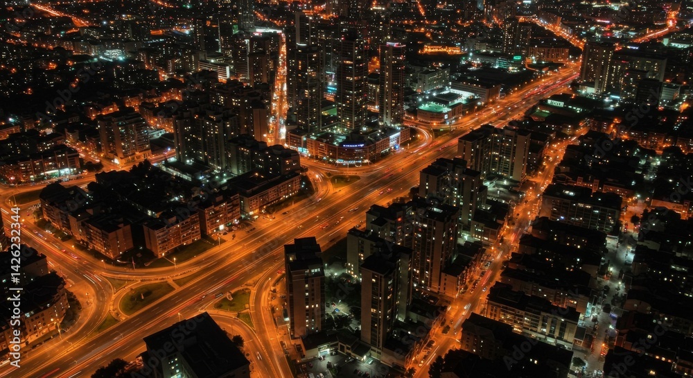 Obraz premium Aerial Night View of Illuminated Cityscape - A captivating aerial view of a city at night, showcasing illuminated streets, buildings, and intricate road networks. Symbolizing urban energy