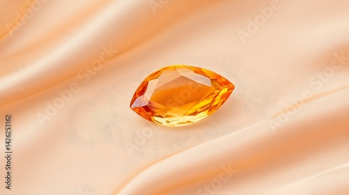Radiant orange gemstone on peach silk