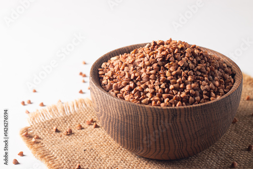 Buckwheat groats on wooden background. Healthy cereal concept.  
