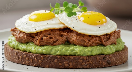 Gourmet Avocado Toast with Pulled Pork and Fried Eggs - Indulgent gourmet breakfast featuring creamy avocado toast, savory pulled pork, sunny-side up fried eggs photo