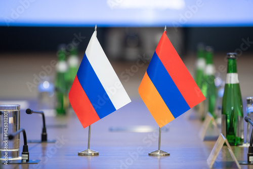 Flags of cooperation between Russia and Armenia. Flags of Russia and Armenia on the negotiating table. Ideal for news.