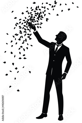Silhouette of businessman reaching for falling leaves or confetti black and white