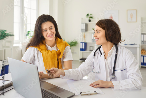 Doctor physician or nurse conducting a conversation with a patient during a consultation in a clinic office. Medical advice, healthcare support, and reassurance to address personal health concerns.