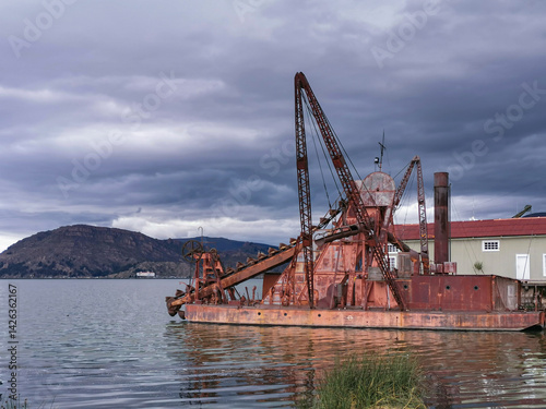 Dredger with continuous hopper on the lake shore photo