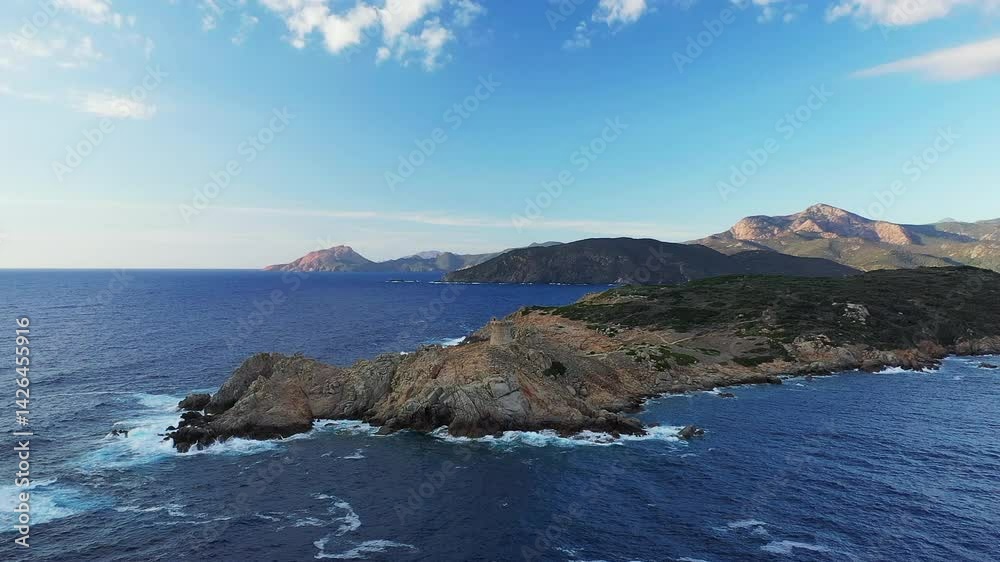 The arid countryside touches Cargese and its tower, in Europe, in France, in Corsica, towards Ajaccio, on the edge of the Mediterranean Sea, in summer, on a sunny day. The arid countryside touches Cargese and its tower, in Europe, in France, in Corsica, towards Ajaccio, on the edge of the Mediterranean Sea, in summer, on a sunny day.