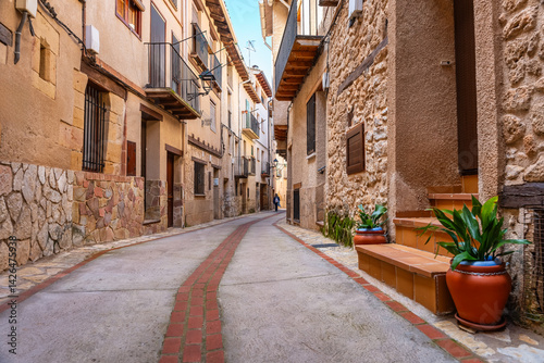 Tourist woman strolling through the picturesque streets of the beautiful medieval town of Beceite, Teruel.