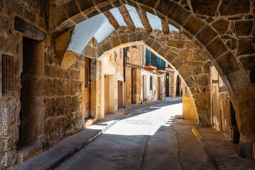 Beautiful corner of the town of Beceite with stone arches that form the houses on the narrow streets, Teruel.