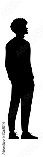 Silhouette of a young Black man standing confidently with hands in pockets.