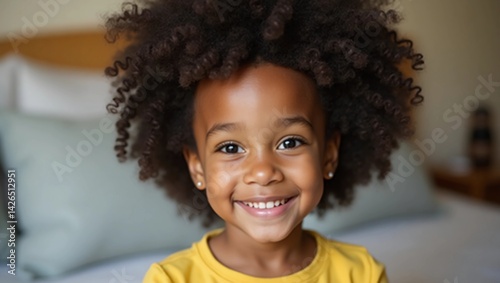 Wallpaper Mural Smiling cute little african american girl looking at camera. Portrait of happy female child at home. Smiling face a of black 4 year old girl looking at camera with afro puff hair Torontodigital.ca