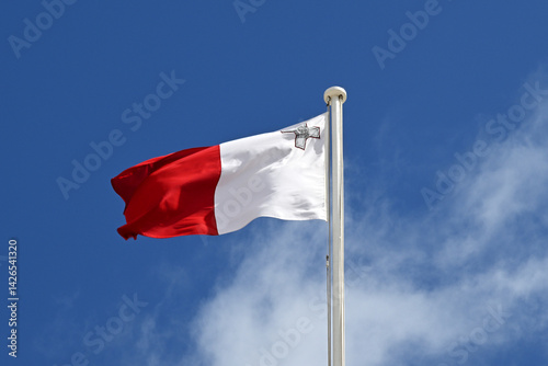 Malta national flag against blue sky