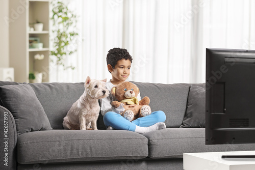 Wallpaper Mural Boy sitting on a sofa with a teddy bear and a dog Torontodigital.ca