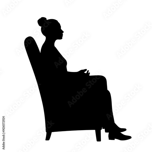 Silhouette of a woman seated contemplatively in a chair  