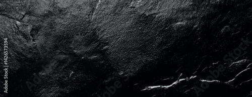 Dark black background with a textured, rough surface. The black background adds a dramatic, moody effect with subtle variations in texture. Textured stone background vector. Black background.