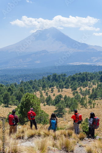 Hikers admiring popocatepetl volcano in mexico photo