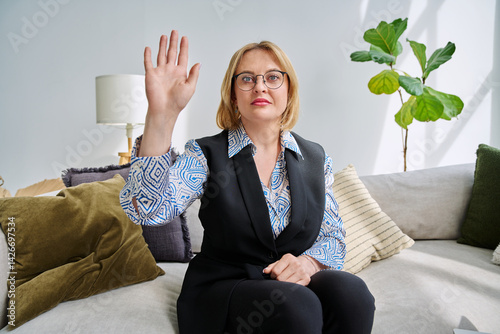 Webcam view middle aged businesswoman looking waving hand in camera