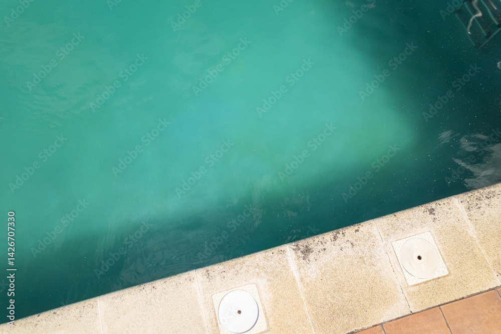 Fototapeta premium light colored pool edge and vibrant turquoise water border