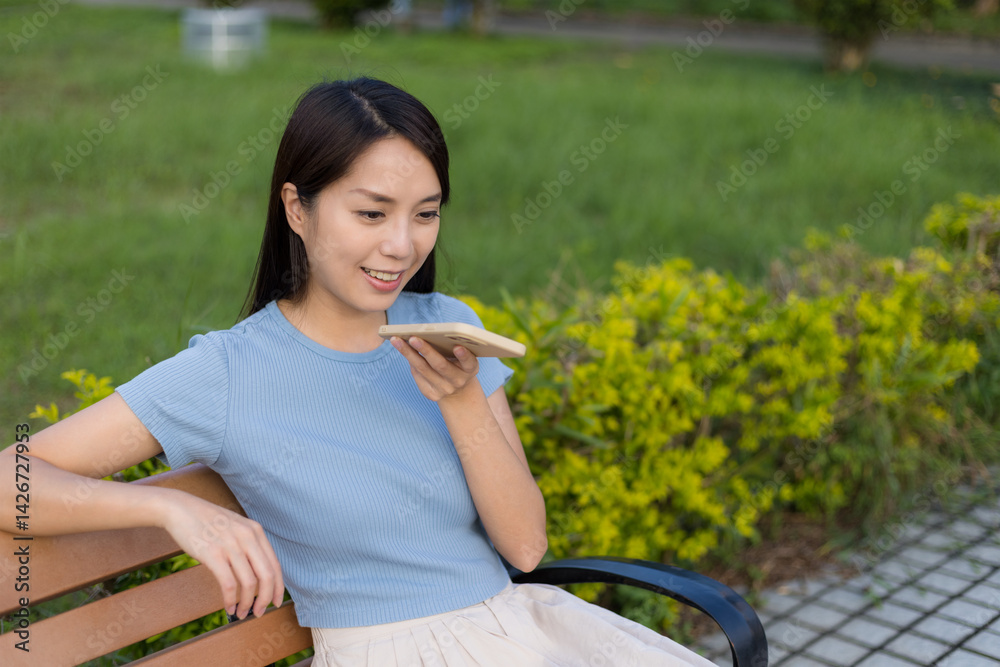 Woman using voice command on mobile phone