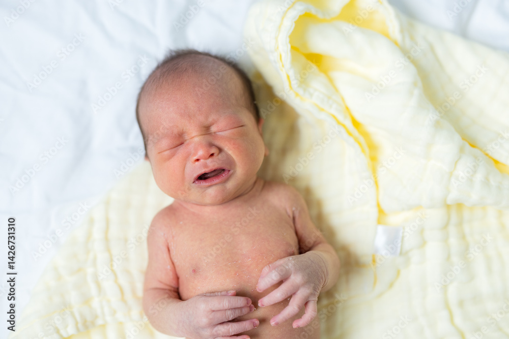 Crying newborn baby showing strong emotion
