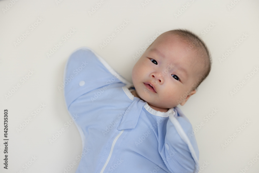 Peaceful newborn baby napping in swaddle wrap