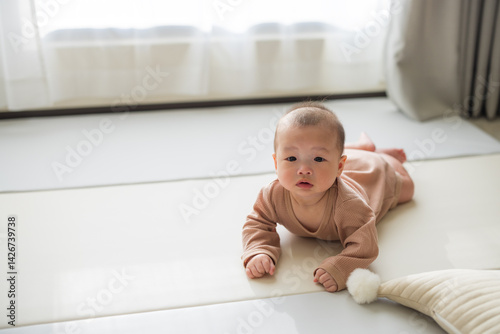 Infant lying on floor with natural daylight