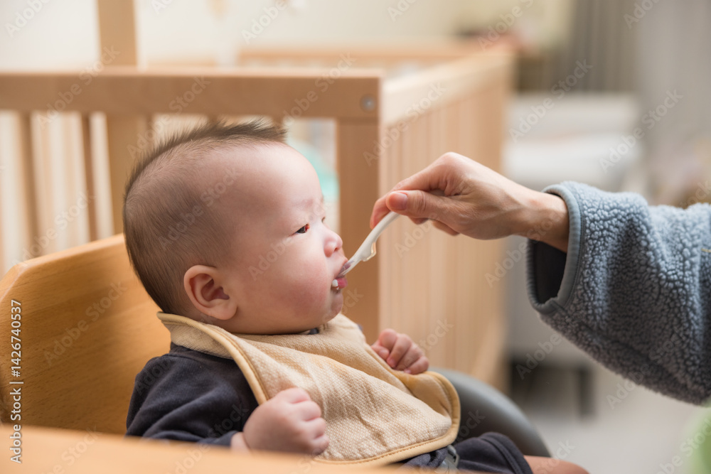 Cute baby sitting while eating meal
