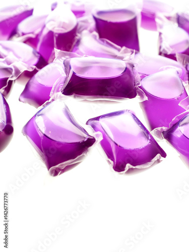 Purple color washing pods on white background. Hygiene product for use in washing machine.