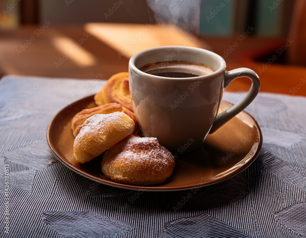A steaming cup of strong Cuban coffee, dark and aromatic, sits beside a small plate of sweet pastries, suggesting a traditional morning ritual. A steaming cup of strong Cuban coffee, dark and aromatic, sits beside a small plate of sweet pastries, suggesting a traditional morning ritual.