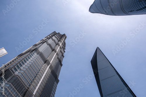 Obraz na płótnie Shanghai city buildings against blue sky, High rise business offices, low angle w salonie