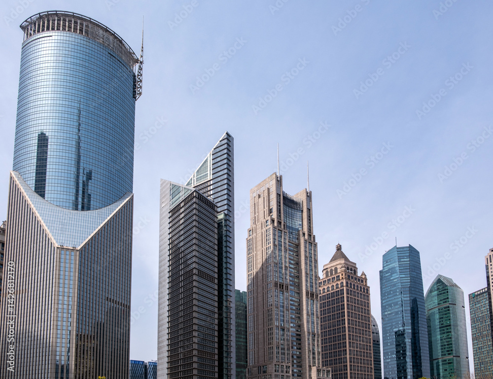Shanghai, China, city buildings. Modern skyscrapers against blue sky, high rise glass office business towers