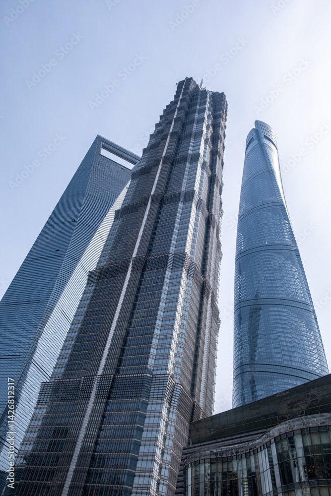 Shanghai, China, city buildings. Modern skyscrapers against blue sky, high rise glass office business towers