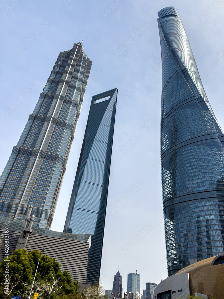 Shanghai city high rise buildings against blue sky, China. Business skyscrapers low angle view.