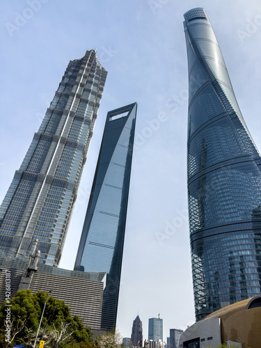 Obraz na płótnie Shanghai city high rise buildings against blue sky, China. Business skyscrapers low angle view. w salonie