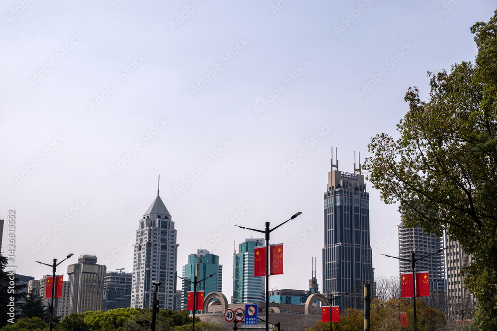 China, Shanghai city downtown. High rise buildings, chinese flags and traffic signs