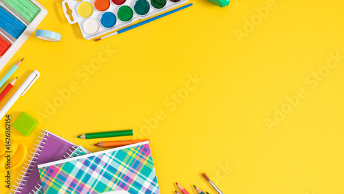 Fototapeta Naklejka Na Ścianę i Meble -  Back to school concept. Frame made of colorful school supplies, paints, plasticine, notepad, scissors, pens, sharpener on a yellow background. Flat lay, top view, copy space.