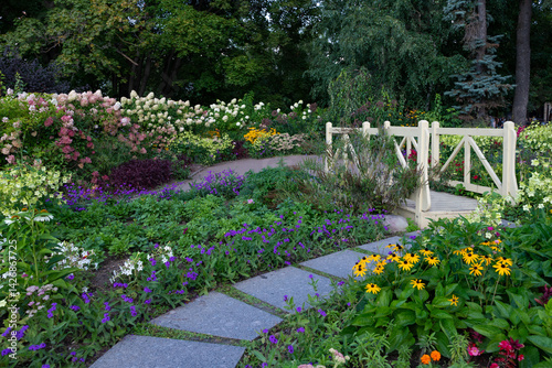 Garden Path with Bridge Surrounded by Flowers