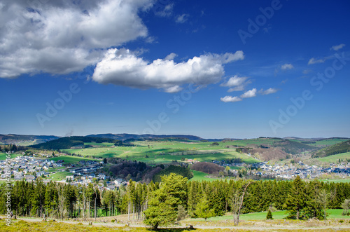 Scenic rural village with green spring hills