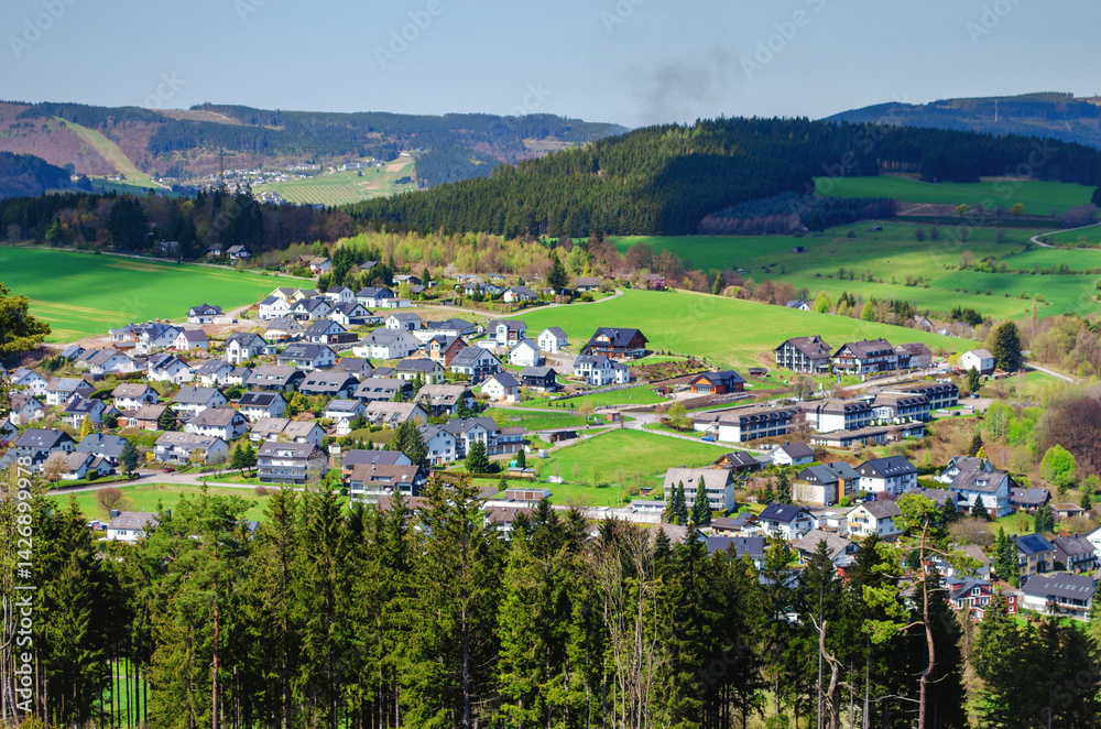 Scenic rural village with green spring hills