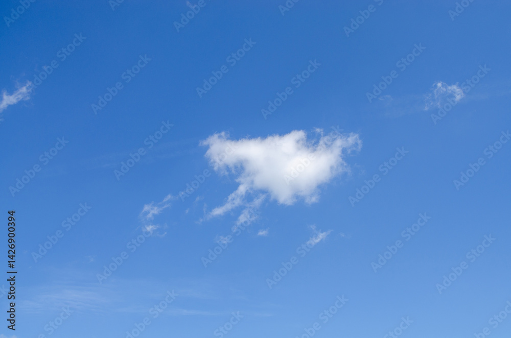 White irregular clouds against a blue beautiful sky in summer