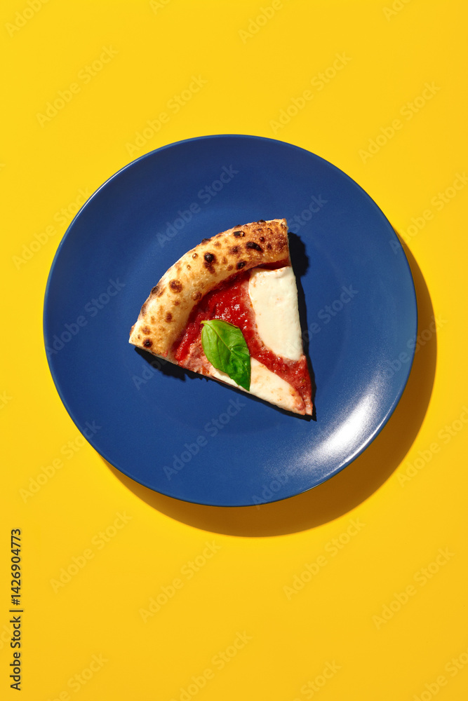 Slice of delicious pizza margherita resting on blue plate with yellow background